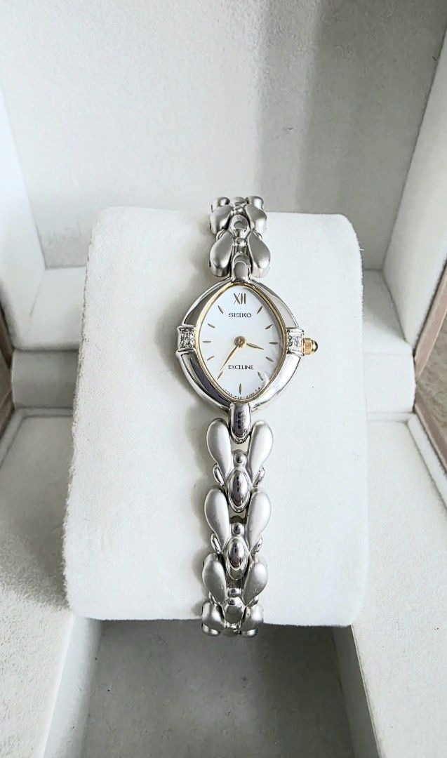 Seiko Excelline ladies watch (Category: Women's Watches) located in Mandaluyong City. Submitted by paulitol (Listing ID 1427628576, Image 2). Description: Very dainty! In excellent condition and in working order; very minimal signs of use. No noticeable scratch. Rfs: Impulse buy, not being used Specs: Silver with gold accents Wrist fits up to 18cm Includes: Watch only (with working battery) w/ generic box/cushion All original head, buckle, and st