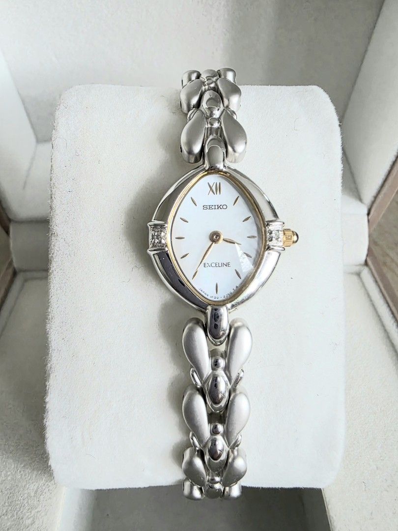 Seiko Excelline ladies watch (Category: Women's Watches) located in Mandaluyong City. Submitted by paulitol (Listing ID 1427628576, Image 1). Description: Very dainty! In excellent condition and in working order; very minimal signs of use. No noticeable scratch. Rfs: Impulse buy, not being used Specs: Silver with gold accents Wrist fits up to 18cm Includes: Watch only (with working battery) w/ generic box/cushion All original head, buckle, and st