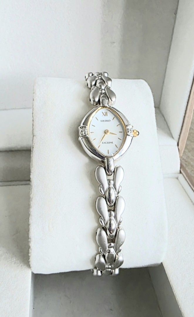 Seiko Excelline ladies watch (Category: Women's Watches) located in Mandaluyong City. Submitted by paulitol (Listing ID 1427628576, Image 3). Description: Very dainty! In excellent condition and in working order; very minimal signs of use. No noticeable scratch. Rfs: Impulse buy, not being used Specs: Silver with gold accents Wrist fits up to 18cm Includes: Watch only (with working battery) w/ generic box/cushion All original head, buckle, and st