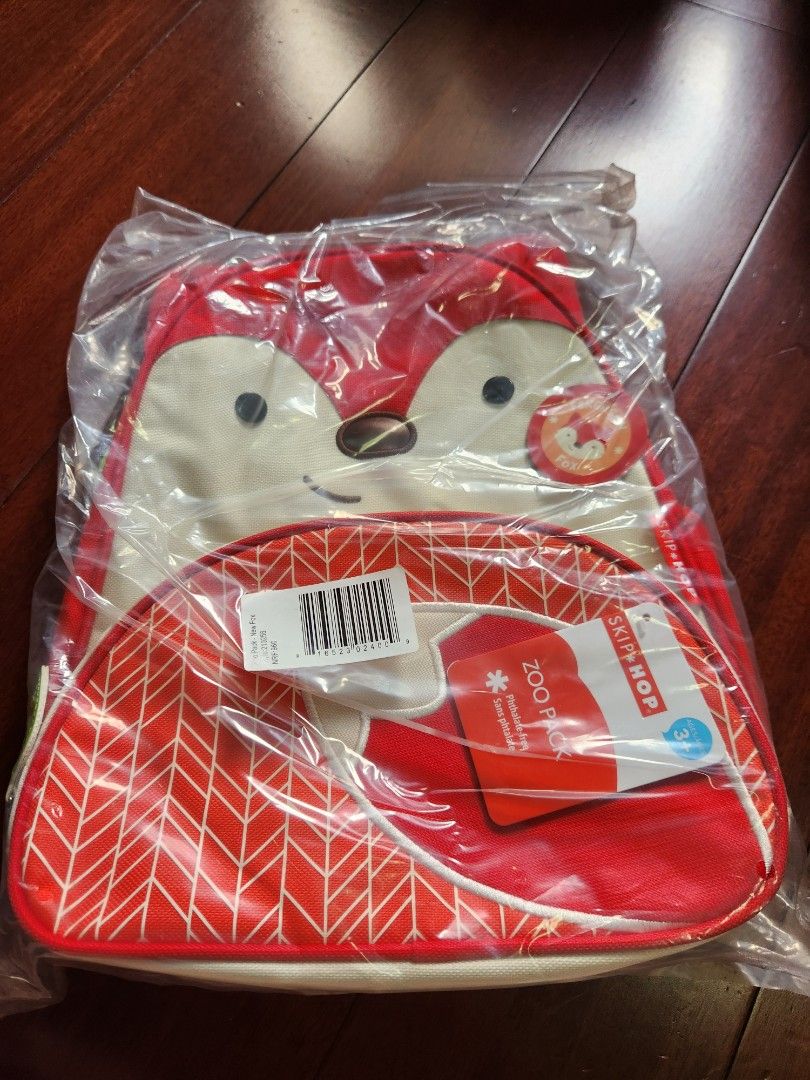 Skip Hop Zoo backpack (Category: Diaper Bags & Wetbags) located in Makati City. Submitted by mikamix (Listing ID 1427502696, Image 1). Description: Skip Hop Zoo Pack lunch bag features a cute fox design. The bag has a red and white color scheme with a patterned design on the side. It includes a handle and adjustable straps. The bag is designed for kids and is perfect for carrying lunches..