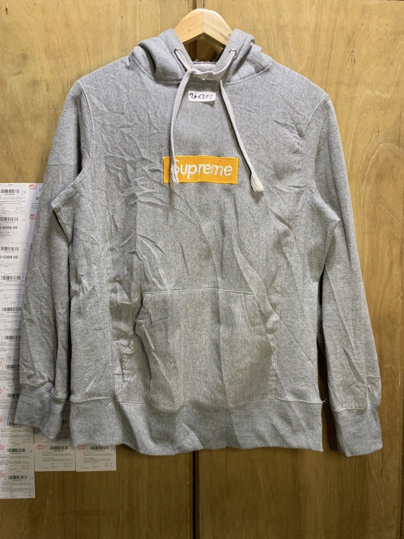 Supreme Box Logo Hoodie (Category: Hoodies) located in Manila. Submitted by thriftstwodrips (Listing ID 1427513037, Image 1). Description: Supreme Box Logo hoodie in grey. Features a yellow box logo on the chest and a small Supreme tag on the sleeve. Made of 100% cotton. Includes a hood with drawstrings and a kangaroo pocket. Made in Canada..