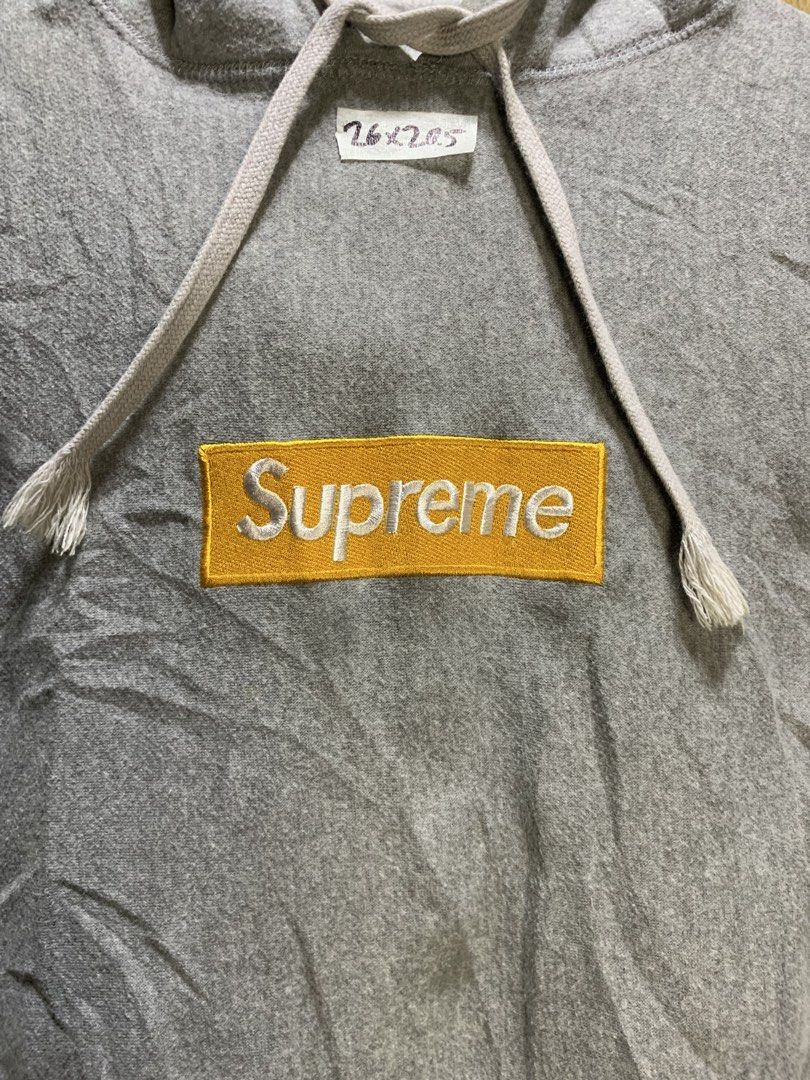 Supreme Box Logo Hoodie (Category: Hoodies) located in Manila. Submitted by thriftstwodrips (Listing ID 1427513037, Image 2). Description: Supreme Box Logo hoodie in grey. Features a yellow box logo on the chest and a small Supreme tag on the sleeve. Made of 100% cotton. Includes a hood with drawstrings and a kangaroo pocket. Made in Canada..