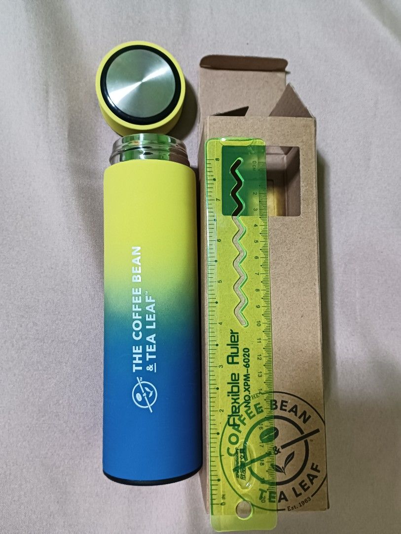 The Coffee Bean & Tea Leaf Tumbler (Category: Water Bottles & Tumblers) located in Manila. Submitted by iamwhilmz (Listing ID 1427607848, Image 3). Description: Tumbler from The Coffee Bean & Tea Leaf features a gradient design with yellow and blue colors. It comes with a lid and is packaged in its original box. The tumbler has the brand's logo printed on the side. A ruler is included in the images for size reference..
