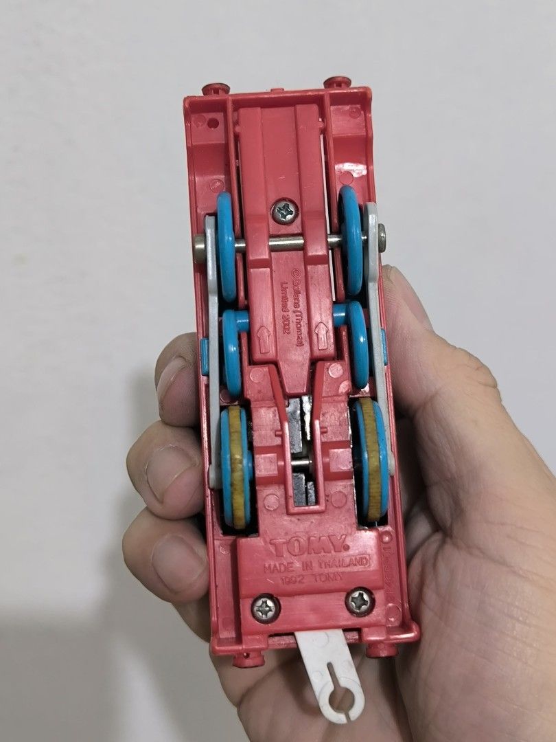 Tomica Thomas the Tank Engine Train (Category: Vehicle & Diecast Models) located in Angeles City. Submitted by yellowbrickstore (Listing ID 1427507933, Image 2). Description: Tomica Thomas the Tank diecast Engine toy train. It is blue with a red base and has the number 1 on its side. The train is made in Thailand. The wheels are blue and yellow. The underside of the train has the Tomica logo and other markings shipping via jnt express sat sked on