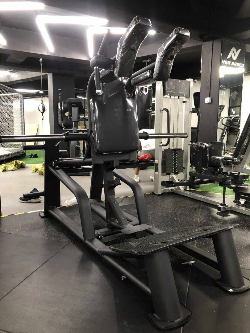 V Squat (Category: Weights & Dumbbells) located in Caloocan City. Submitted by protein888 (Listing ID 1427624529, Image 2). Description: Heavy-duty squat machine designed for commercial gym use. Features a padded back and shoulder support for comfort and safety. Includes a foot platform and weight bar. Ideal for building lower body strength. Sturdy construction ensures stability during workouts. Perfect for serious fitness enthusiasts..