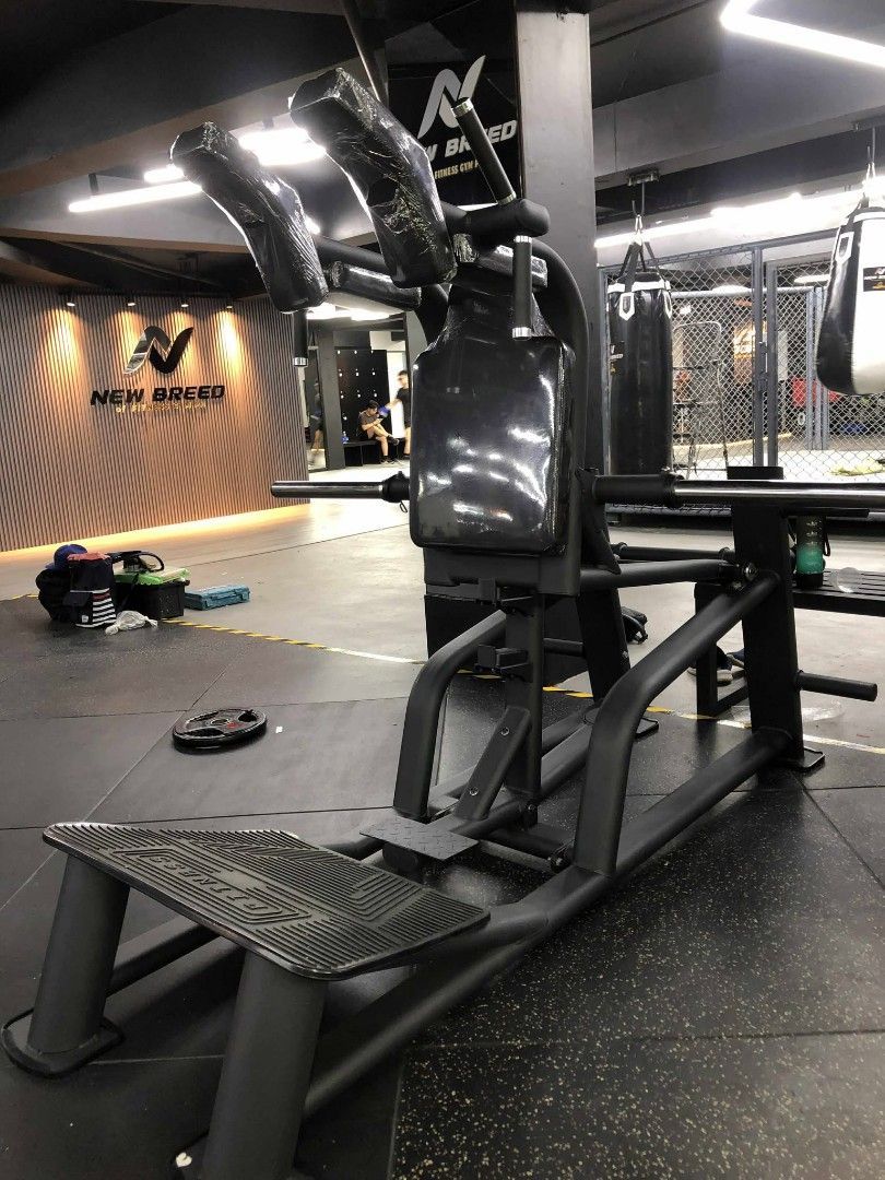 V Squat (Category: Weights & Dumbbells) located in Caloocan City. Submitted by protein888 (Listing ID 1427624529, Image 3). Description: Heavy-duty squat machine designed for commercial gym use. Features a padded back and shoulder support for comfort and safety. Includes a foot platform and weight bar. Ideal for building lower body strength. Sturdy construction ensures stability during workouts. Perfect for serious fitness enthusiasts..