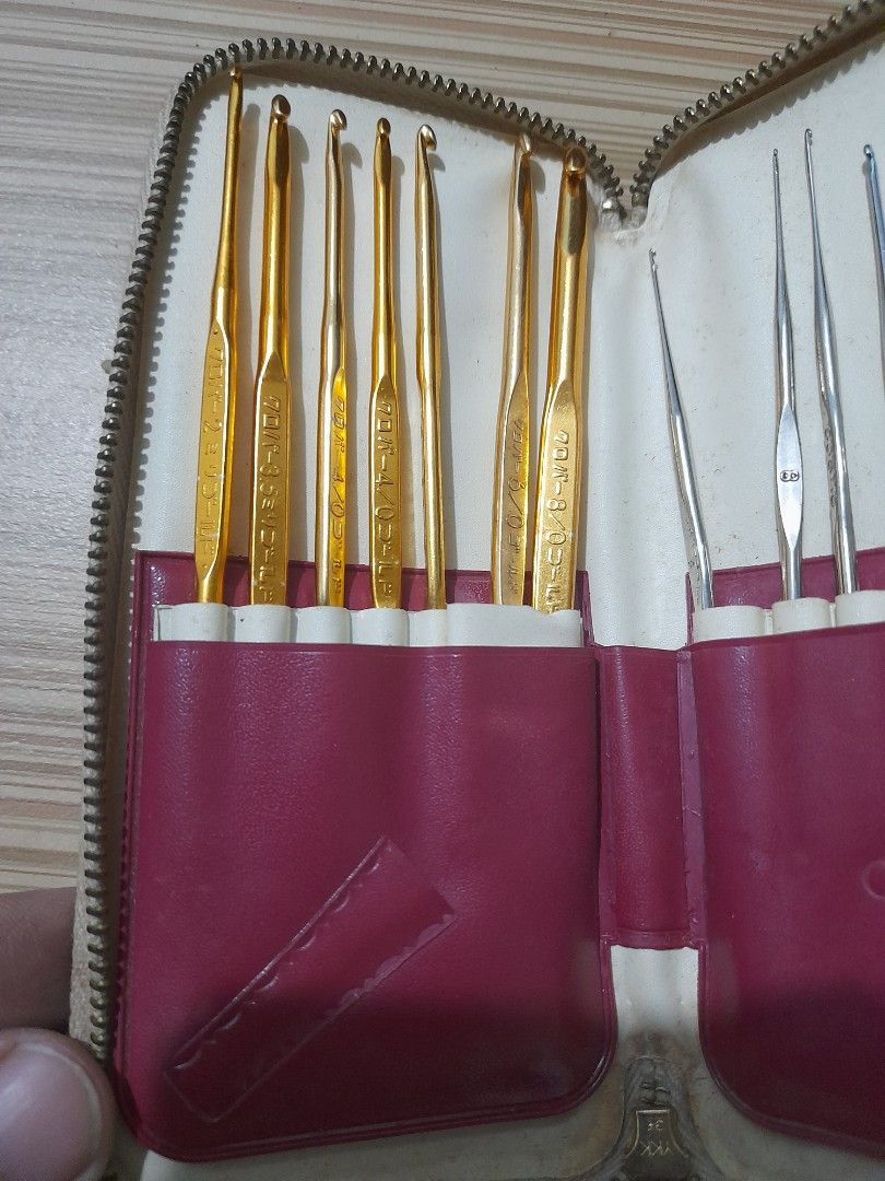 Vintage Crochet Hook Set (Category: Craft Supplies & Tools) located in Bocaue. Submitted by marajapansurplus (Listing ID 1427512276, Image 2). Description: Vintage crochet hook set includes both silver and gold hooks. The set comes in a zippered case with individual slots for each hook. The gold hooks have Japanese markings. The case has a red interior and a cream-colored exterior. A great set for crocheting enthusiasts..