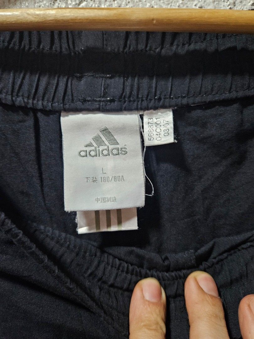 Adidas Black Shorts with White Stripes (Category: Shorts) located in Quezon City. Submitted by itsmeriaa (Listing ID 1427732697, Image 3). Description: Adidas black shorts with white stripes. Features the Adidas logo and size tag. The shorts have an elastic waistband. The shorts have the classic Adidas three-stripe design on the side. DIMES ✔️ W : 32 L : 30.5 Color rate : 9/10 No issue, in excellent cond. ✨️.
