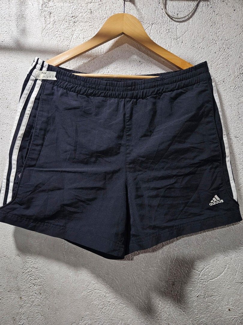 Adidas Black Shorts with White Stripes (Category: Shorts) located in Quezon City. Submitted by itsmeriaa (Listing ID 1427732697, Image 1). Description: Adidas black shorts with white stripes. Features the Adidas logo and size tag. The shorts have an elastic waistband. The shorts have the classic Adidas three-stripe design on the side. DIMES ✔️ W : 32 L : 30.5 Color rate : 9/10 No issue, in excellent cond. ✨️.