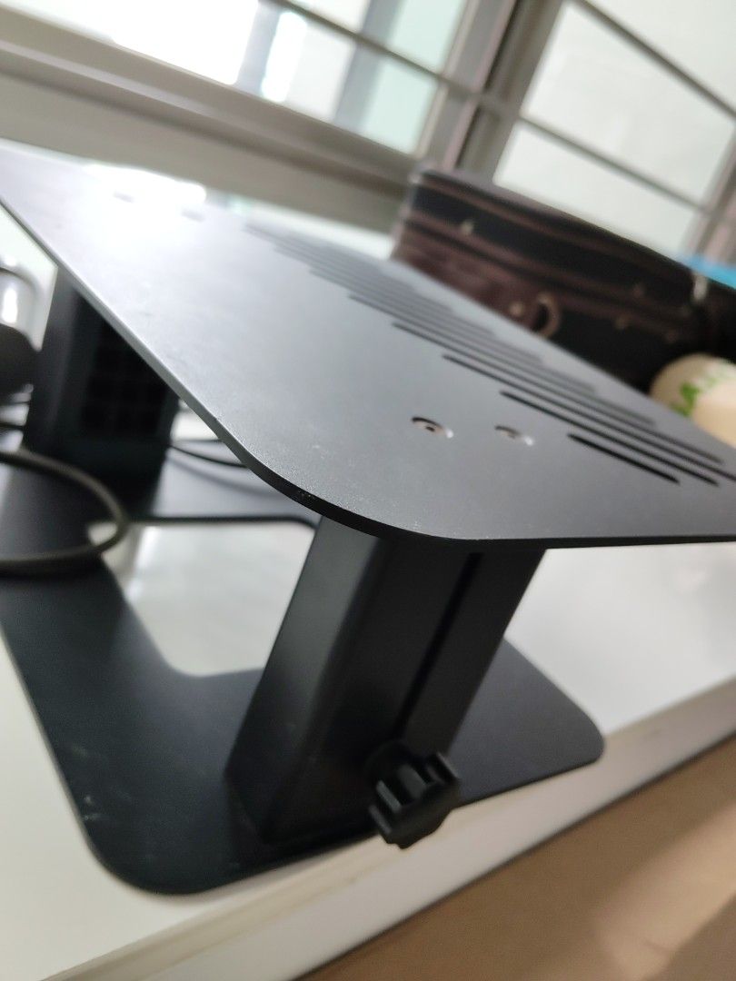 Adjustable desk riser platform (Category: Tables & Sets) located in Singapore. Submitted by julitang25774 (Listing ID 1427653087, Image 2). Description: Black license plate mount. The mount has a unique design with angled slots. It looks sturdy and ready to install. Includes mounting hardware..