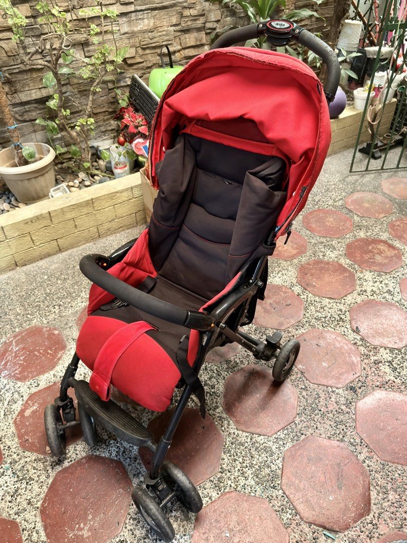 Aprica Red Stroller (Category: Strollers) located in Pasig City. Submitted by mamasboyforlife (Listing ID 1427643615, Image 2). Description: Wheels work perfectly. Cushion needs washing..