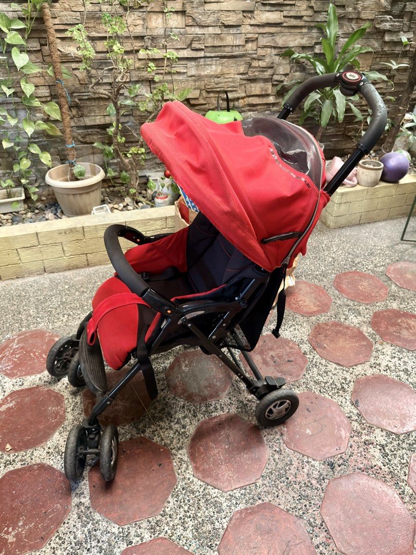 Aprica Red Stroller (Category: Strollers) located in Pasig City. Submitted by mamasboyforlife (Listing ID 1427643615, Image 3). Description: Wheels work perfectly. Cushion needs washing..