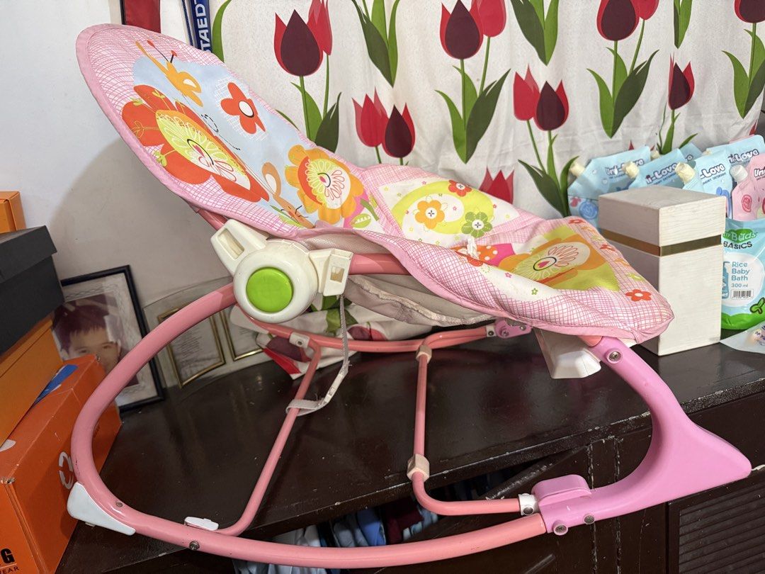 Baby Rocking Chair (Category: Kids Tables & Chairs) located in Quezon City. Submitted by chi_declutters (Listing ID 1427645576, Image 2). Description: TiiBaby baby rocking chair features a colorful floral and animal design. It has a pink frame and a safety harness. It is suitable for infants and toddlers. The chair is designed for comfort and entertainment. Rfs: decluterring and need space for toddler toys.