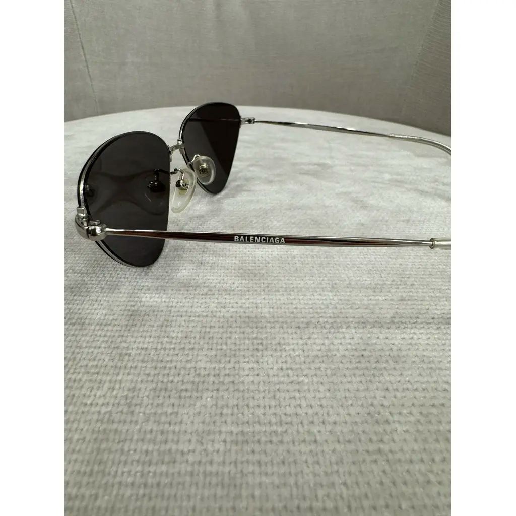 Balenciaga Invisible Cat Sunglasses (Category: Sunglasses & Eyewear) located in Mandaluyong City. Submitted by bethco (Listing ID 1427654327, Image 2). Description: Balenciaga Invisible Cat sunglasses with a silver frame. The lenses are dark with the Balenciaga logo printed all over. Includes a black case and cleaning cloth, both with the Balenciaga logo. The sunglasses have a sleek, modern design..