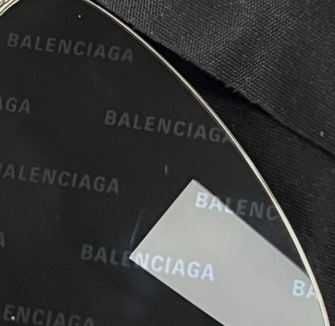 Balenciaga Invisible Cat Sunglasses (Category: Sunglasses & Eyewear) located in Mandaluyong City. Submitted by bethco (Listing ID 1427654327, Image 3). Description: Balenciaga Invisible Cat sunglasses with a silver frame. The lenses are dark with the Balenciaga logo printed all over. Includes a black case and cleaning cloth, both with the Balenciaga logo. The sunglasses have a sleek, modern design..