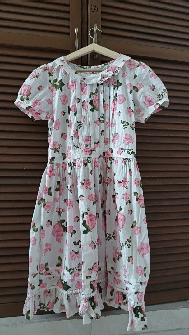 Boshira Floral Dress (Category: Dresses) located in Manila. Submitted by venus_se (Listing ID 1427645062, Image 1). Description: Dress features a charming floral print with pink roses on a white background. It has a round collar, short sleeves, and a gathered waist. The dress also has a ruffled hemline. The label indicates the brand is Boshira and the size is 160/60A(L)..
