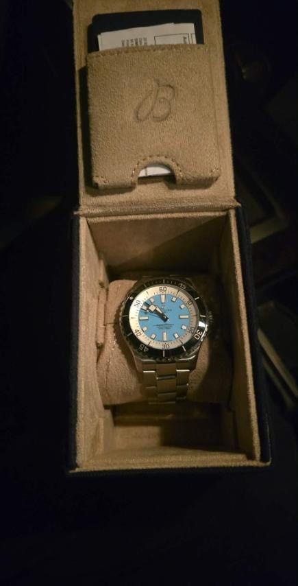 Breitling Superocean Automatic 44 (Category: Luxury Watches) located in Davao. Submitted by slarken (Listing ID 1427697363, Image 3). Description: Breitling Superocean Automatic 44 watch with a striking turquoise dial. Features a stainless steel bracelet and a rotating bezel. Includes the original box and warranty card. The watch is a Swiss-made chronometer..