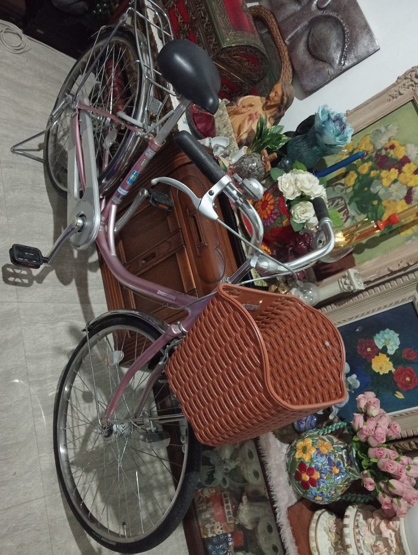 Bridgestone rosegold Bicycle with Basket (Category: Bicycles) located in Batangas. Submitted by girlmeetspurple (Listing ID 1427701732, Image 2). Description: Bridgestone bicycle features a rosegold frame, a comfortable black seat, and a front basket. It has a rear rack for carrying items. The tires are Bridgestone Tough Road. The bike has a classic design with fenders over the wheels. ✅from Japan 🇯🇵 ✅in very good condition.
