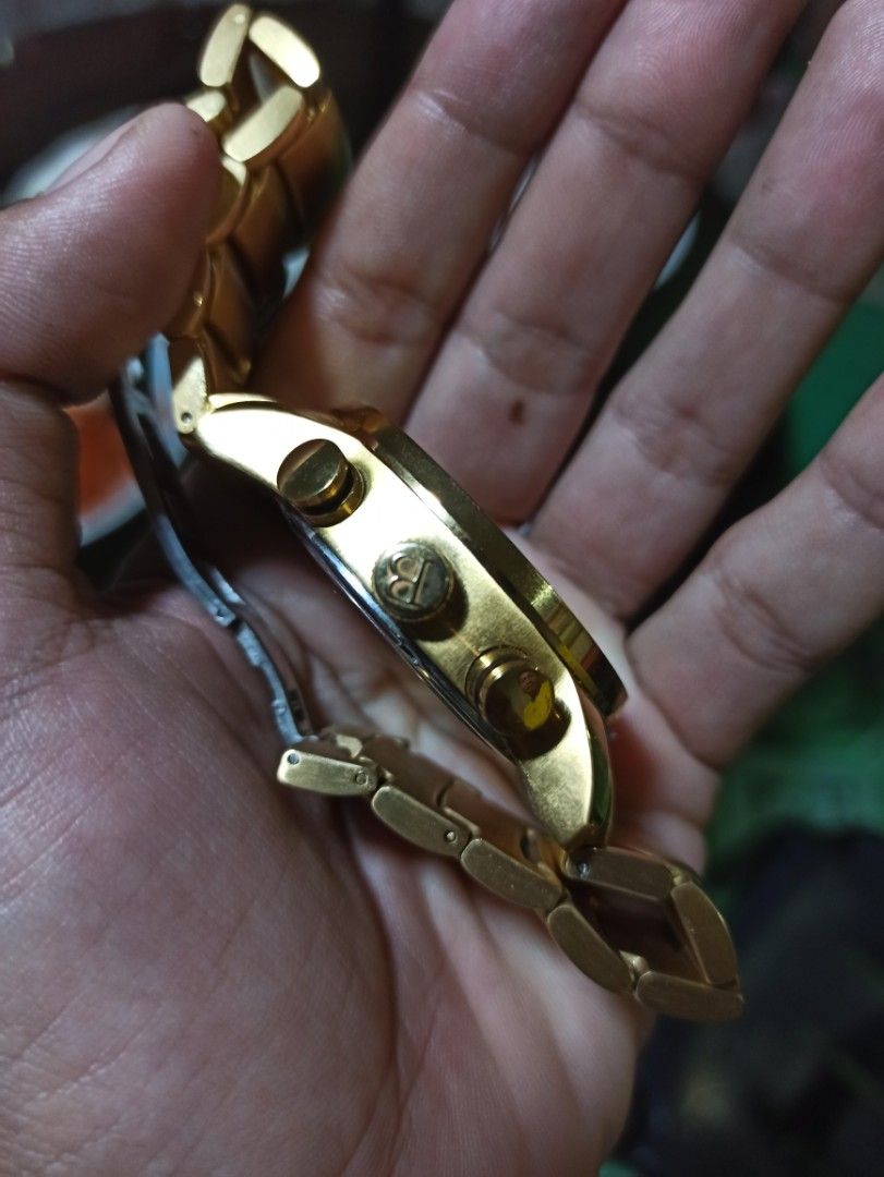 Bvlgari Watch (Category: Luxury Watches) located in Tagbilaran City. Submitted by delasierra39181 (Listing ID 1427734755, Image 2). Description: Gold-toned Bvlgari watch with a skeleton dial. Features a tachymeter and chronograph functions. The watch has a gold bracelet strap and a clasp closure. The back of the watch indicates it is made in Switzerland and is numbered out of 1000. The watch has a unique design with visible internal mechanisms..