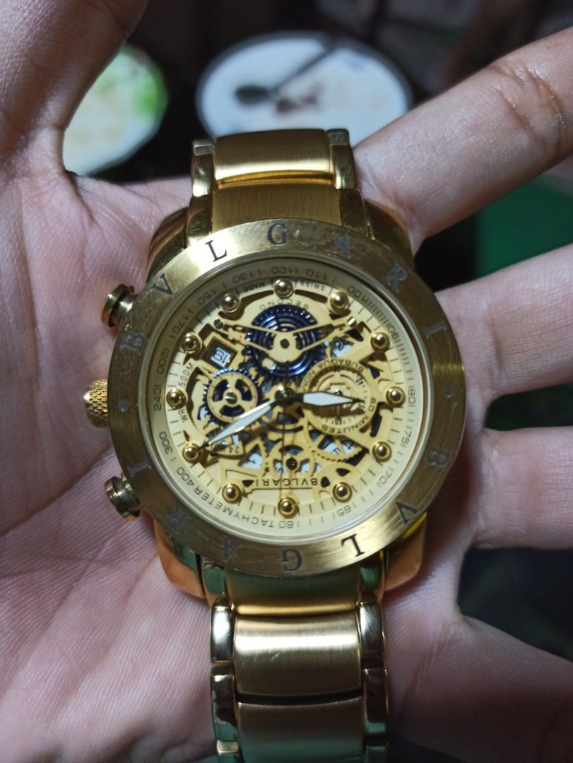 Bvlgari Watch (Category: Luxury Watches) located in Tagbilaran City. Submitted by delasierra39181 (Listing ID 1427734755, Image 1). Description: Gold-toned Bvlgari watch with a skeleton dial. Features a tachymeter and chronograph functions. The watch has a gold bracelet strap and a clasp closure. The back of the watch indicates it is made in Switzerland and is numbered out of 1000. The watch has a unique design with visible internal mechanisms..