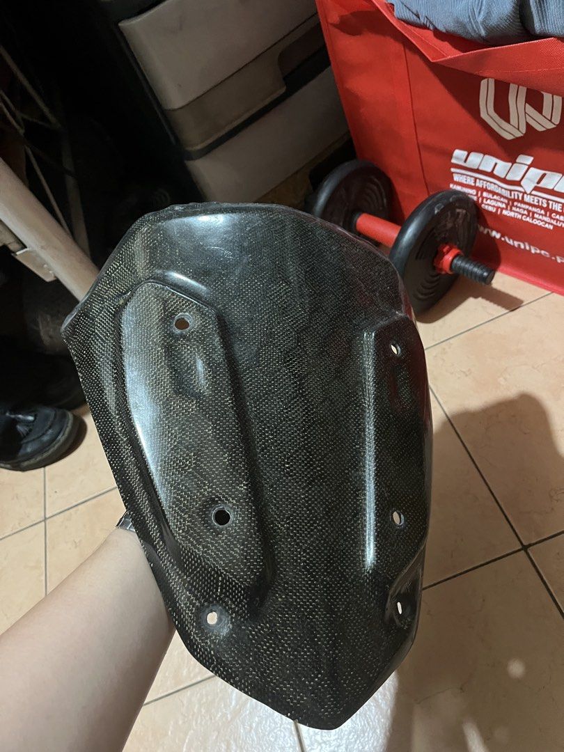 Carbon Nmax V2 Visor (Category: Helmets and other Riding Gears) located in Manila. Submitted by roimatthewww (Listing ID 1427746270, Image 1). Description: FOR NMAX V2 See pics for issues - Carbon fiber motorcycle fairing - Front fairing design - Multiple mounting holes - Textured carbon fiber weave - Minor crack on the edge.