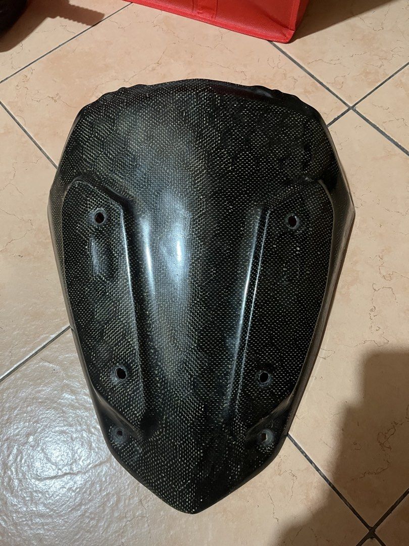 Carbon Nmax V2 Visor (Category: Helmets and other Riding Gears) located in Manila. Submitted by roimatthewww (Listing ID 1427746270, Image 2). Description: FOR NMAX V2 See pics for issues - Carbon fiber motorcycle fairing - Front fairing design - Multiple mounting holes - Textured carbon fiber weave - Minor crack on the edge.