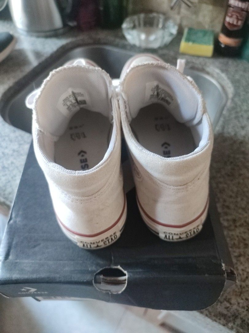 Converse All Star High Top White (Category: Sneakers) located in Quezon City. Submitted by PaidTY (Listing ID 1427687438, Image 2). Description: Needs cleaning lang pero hindi nagamit masyado. Bought for Php 3,490 with box pa. rfs: outgrown by my daughter Size: US 6 , 23 cm Classic Converse All Star high-top sneakers in white. Features the iconic Converse All Star logo on the side and tongue. Includes the original box. The soles show some wear. T