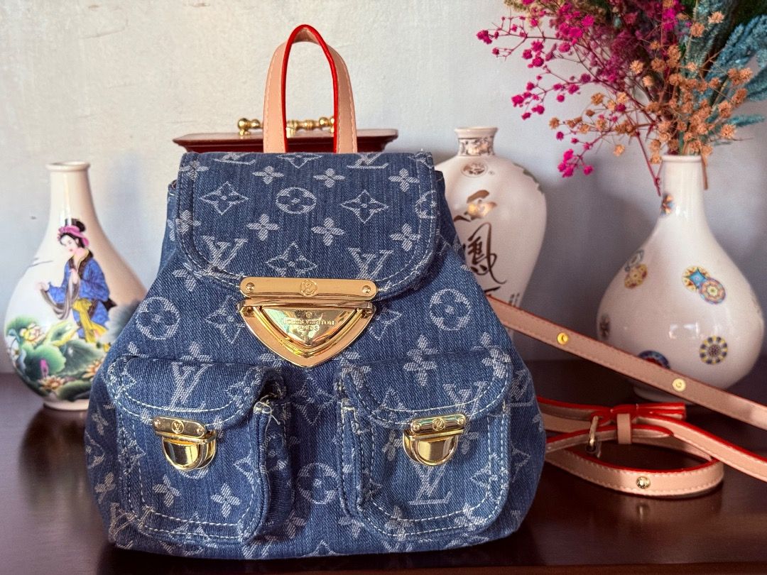 Cute Mini Denim Bag (Category: Luxury Bags & Wallets) located in Cotabato. Submitted by goldenhiveph0826 (Listing ID 1427712757, Image 1). Description: ❤️○ Stylish denim backpack with LV monogram pattern ❤️○ Gold hardware, pink leather handles/straps, red trim ❤️○ Spacious interior, like-new condition with minimal signs of use ❤️• Features: Two front pockets, flap closure, adjustable straps. ✅• Perfect for: School, work, or weekend trips ✅• Dimen