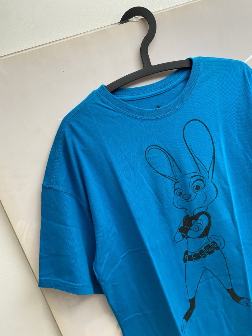 Disney Zootopia Judy Hopps Graphic Tee (Category: Tshirts & Polo Shirts ) located in Pasig City. Submitted by greatestpickup (Listing ID 1427673456, Image 3). Description: Blue t-shirt features a graphic of Judy Hopps from Zootopia. The design is printed on the front of the shirt. The shirt is a vibrant blue color. disney judy hopps xl on tag 23x29 350.