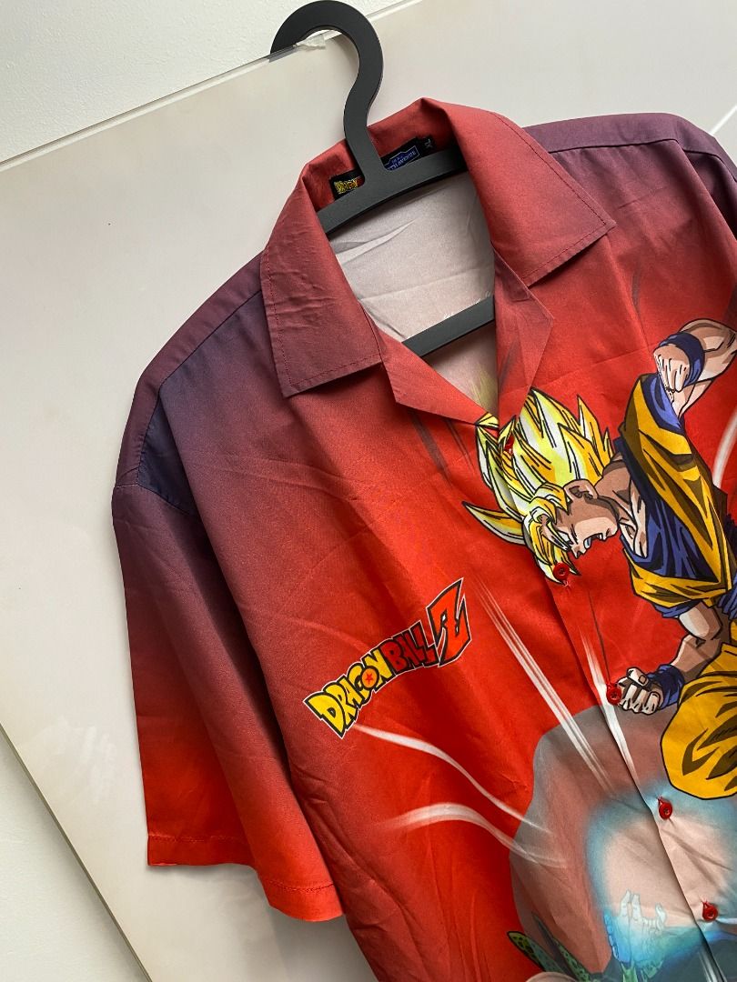 Dragon Ball Z Button-Up Shirt (Category: Tshirts & Polo Shirts ) located in Pasig City. Submitted by greatestpickup (Listing ID 1427689669, Image 2). Description: Button-up shirt features Dragon Ball Z characters Goku and Cell on the front, and Gohan and Cell on the back. The shirt has a red base color with a gradient effect. It has short sleeves and a collared neckline. The shirt has a button-up closure. dbz aop polo xl on tag 24x30 1500 .