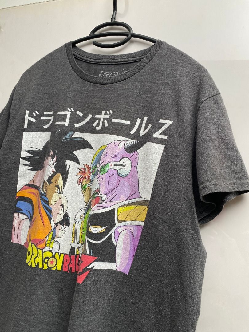 Dragon Ball Z Graphic Tee (Category: Tshirts & Polo Shirts ) located in Pasig City. Submitted by greatestpickup (Listing ID 1427678144, Image 3). Description: Dragon Ball Z graphic tee features a design with Goku and other characters. The shirt is dark gray. dbz face off m on tag 21.5 x 26 500.