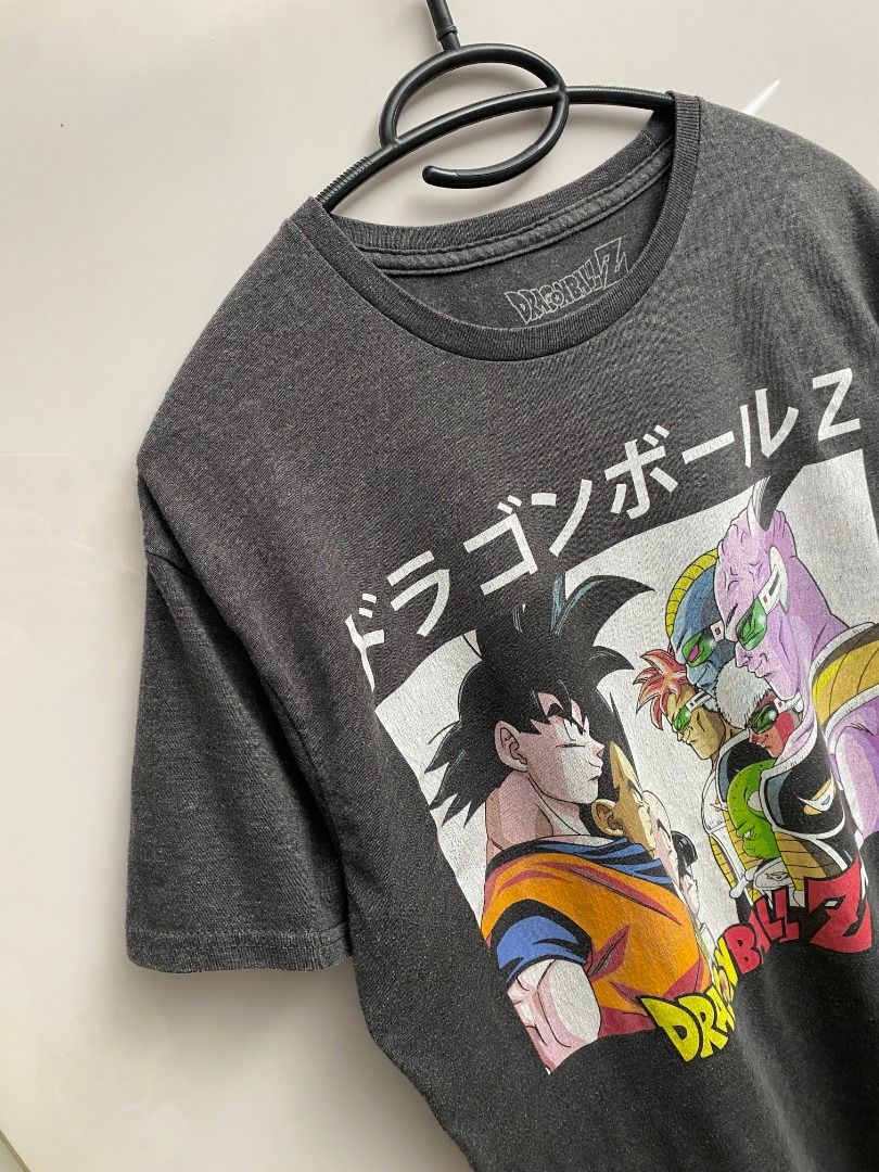 Dragon Ball Z Graphic Tee (Category: Tshirts & Polo Shirts ) located in Pasig City. Submitted by greatestpickup (Listing ID 1427678144, Image 2). Description: Dragon Ball Z graphic tee features a design with Goku and other characters. The shirt is dark gray. dbz face off m on tag 21.5 x 26 500.