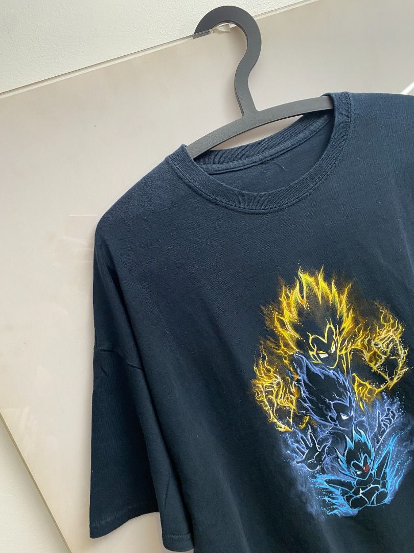 Dragon Ball Z Vegeta Graphic Tee (Category: Tshirts & Polo Shirts ) located in Pasig City. Submitted by greatestpickup (Listing ID 1427690615, Image 3). Description: Black t-shirt features a vibrant graphic of Vegeta in various Super Saiyan forms. The design showcases Vegeta with yellow and blue energy effects. The shirt has a classic crew neck design. dbz trio vegeta 25x30 2000.