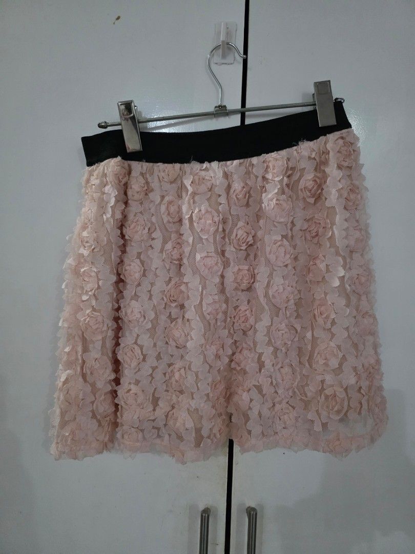Floral Embellished Skirt (Category: Skirts) located in Puerto Princesa. Submitted by kholene (Listing ID 1427683515, Image 1). Description: Skirt features a delicate floral embellishment. It has a black waistband and is made of a light pink fabric. The skirt is adorned with multiple layers of small, rose-shaped details..