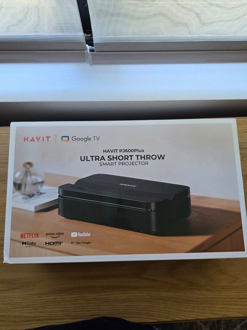 Havit PJ600 Plus Smart Life Series Projector (Category: Projectors) located in Taguig. Submitted by m.cruz (Listing ID 1427681353, Image 2). Description: Havit PJ600 Plus Smart Life Series Projector is an ultra-short throw projector. It supports Google TV and has built-in apps like Netflix, YouTube, and Prime Video. The projector is black and comes in its original packaging. bought in Rustans last January. lost the receipt already. almost new, us