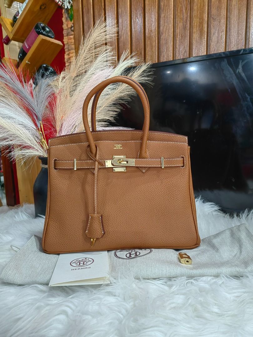 Hermes Birkin Handbag 30cm Tan (Category: Luxury Bags & Wallets) located in Cebu City. Submitted by erlacoleccion (Listing ID 1427716377, Image 1). Description: Elegant Hermes Birkin handbag in a beautiful brown color. Features a classic design with top handles and a secure clasp closure. Includes a dust bag, lock, and care booklet. A timeless piece for any wardrobe..