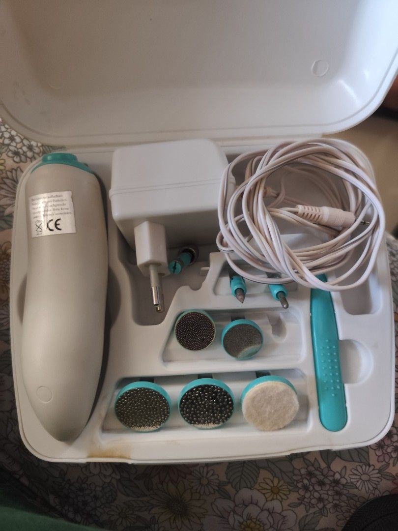 Heru Electric Manicure/Pedicure Set PM 112 (Category: Hands & Nails) located in Cavite. Submitted by mavi.gif (Listing ID 1427675122, Image 2). Description: Heru Electric Manicure/Pedicure Set PM 112. Includes the main device, various attachments for nail care, a power adapter, and a storage case. The device has a white and teal color scheme. - Imported from Germany - Working 100 %.