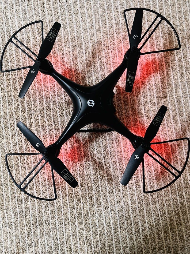 Holy Stone HS-Series HS110D Drone (Category: Drones) located in Subic. Submitted by mr_niceguy001 (Listing ID 1427684742, Image 2). Description: Holy Stone HS110D drone with remote control. Features a built-in camera for aerial photography. Includes the drone, remote control, and battery. The drone has protective guards around the propellers. The remote control has a status display. The drone is black in color..