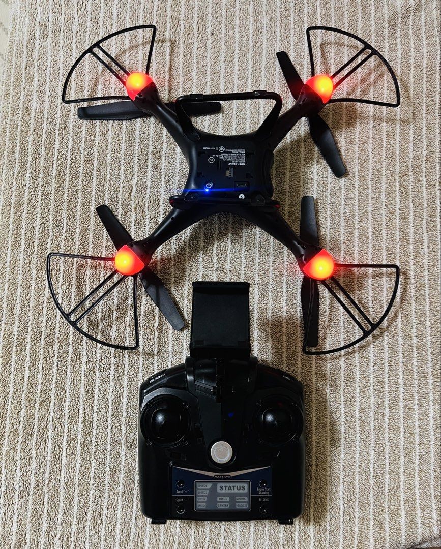 Holy Stone HS-Series HS110D Drone (Category: Drones) located in Subic. Submitted by mr_niceguy001 (Listing ID 1427684742, Image 3). Description: Holy Stone HS110D drone with remote control. Features a built-in camera for aerial photography. Includes the drone, remote control, and battery. The drone has protective guards around the propellers. The remote control has a status display. The drone is black in color..