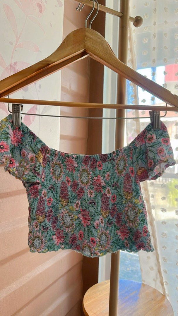 K-D Floral Off-Shoulder Crop Top (Category: Others Tops) located in Cebu City. Submitted by forless.ph (Listing ID 1427663357, Image 1). Description: Floral crop top features an off-shoulder design. It has a smocked bodice and short sleeves. The top is adorned with a colorful floral pattern on a teal background. It is a stylish piece perfect for warm weather. Will fit xsmall - small body frame.