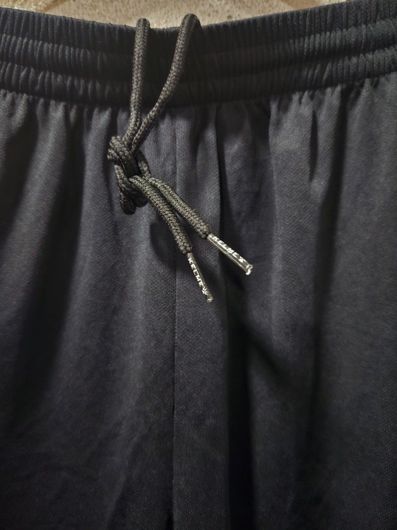 Kelme Black Shorts - XL (Category: Shorts) located in Quezon City. Submitted by itsmeriaa (Listing ID 1427731515, Image 2). Description: Black Kelme shorts with an elastic waistband and drawstring. Features the Kelme logo and the number "6" on the leg. The shorts are size XL, according to the tag. Made in China. The shorts have a paw print logo. DIMES ✔️ W : 30 L : 17.5 Color rate : 10/10 No issue, in excellent cond. ✨️.