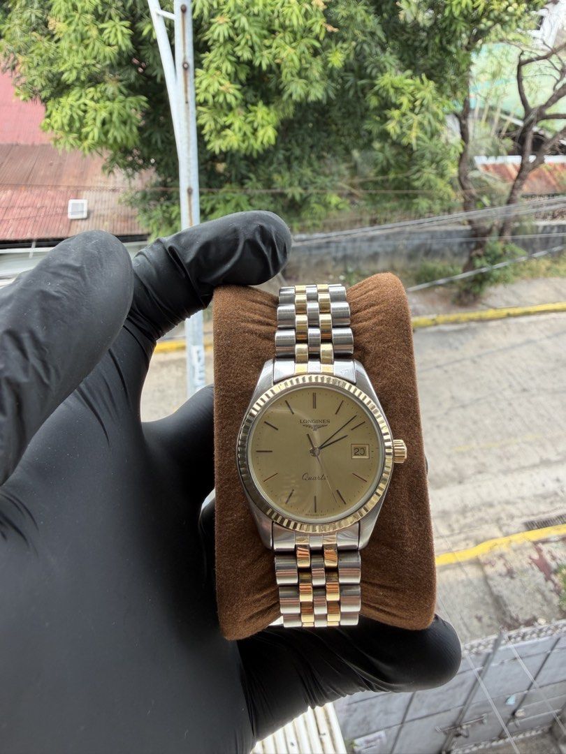 Longines Quartz Two-Tone Watch (Vintage Classic) (Category: Luxury Watches) located in Manila. Submitted by wrist_watch_library (Listing ID 1427682037, Image 2). Description: Brand: Longines Movement: Quartz (battery operated) Case Size: approx. 34mm (classic dress size) Fits wrist: up to 16.5 cm Dial: Gold tone, clean minimalist design Date display at 3 o’clock Original two-tone bracelet (steel + gold) Fluted gold tone bezel Original Longines cl