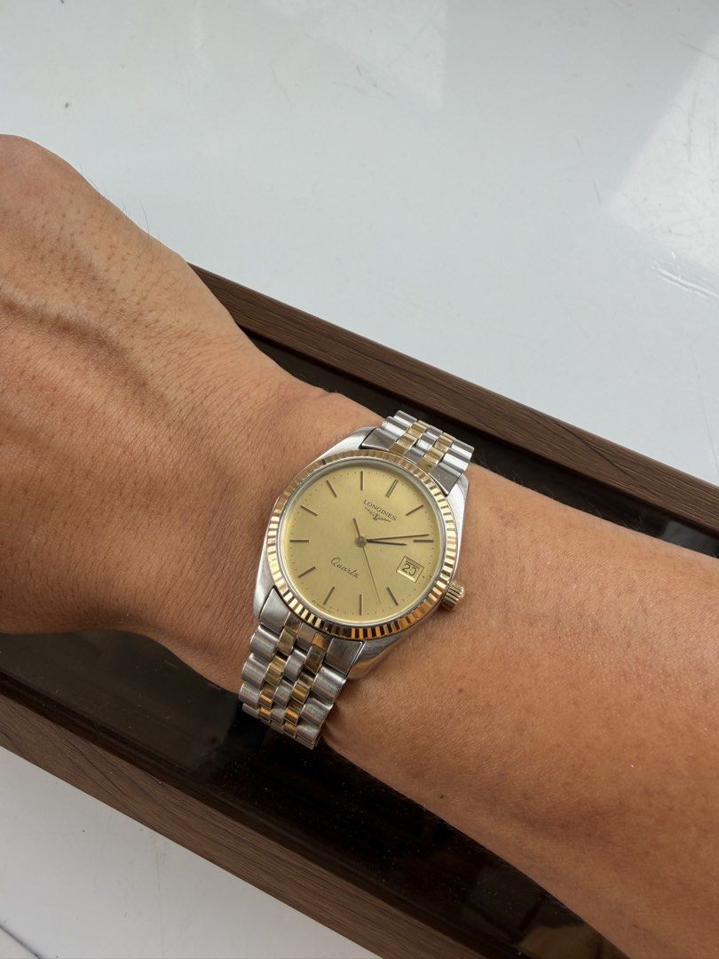 Longines Quartz Two-Tone Watch (Vintage Classic) (Category: Luxury Watches) located in Manila. Submitted by wrist_watch_library (Listing ID 1427682037, Image 1). Description: Brand: Longines Movement: Quartz (battery operated) Case Size: approx. 34mm (classic dress size) Fits wrist: up to 16.5 cm Dial: Gold tone, clean minimalist design Date display at 3 o’clock Original two-tone bracelet (steel + gold) Fluted gold tone bezel Original Longines cl