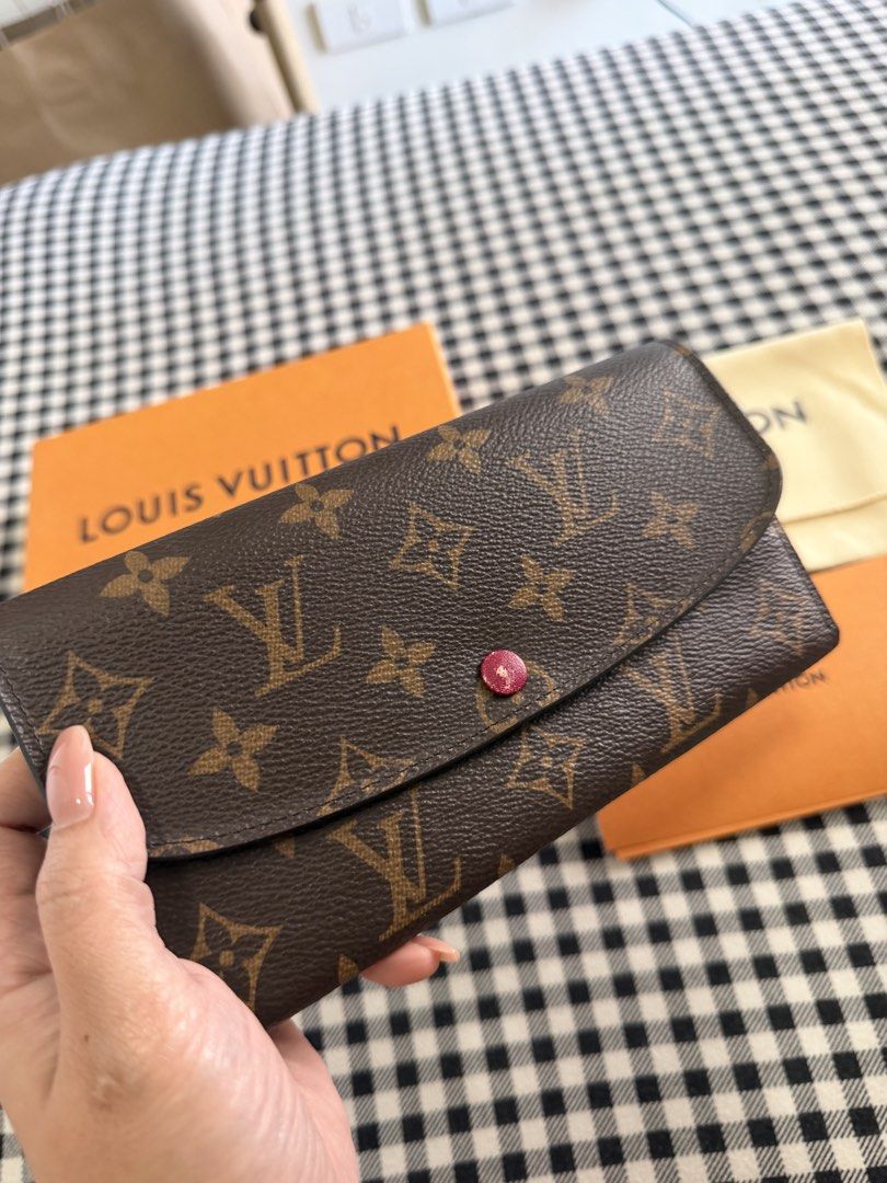 Louis Vuitton Emilie Monogram Wallet (Category: Luxury Bags & Wallets) located in Pasig City. Submitted by sugarspicesalve (Listing ID 1427668196, Image 2). Description: 👛 Louis Vuitton Emilie Wallet Monogram (Red Button) 💰 Price: ₱18,000 (negotiable for sure buyers) ✨ Selling my authentic LV Emilie Wallet in classic Monogram canvas with red interior / red snap button Slim, lightweight, and perfect for everyday use ✔️ Features: • Multiple card 