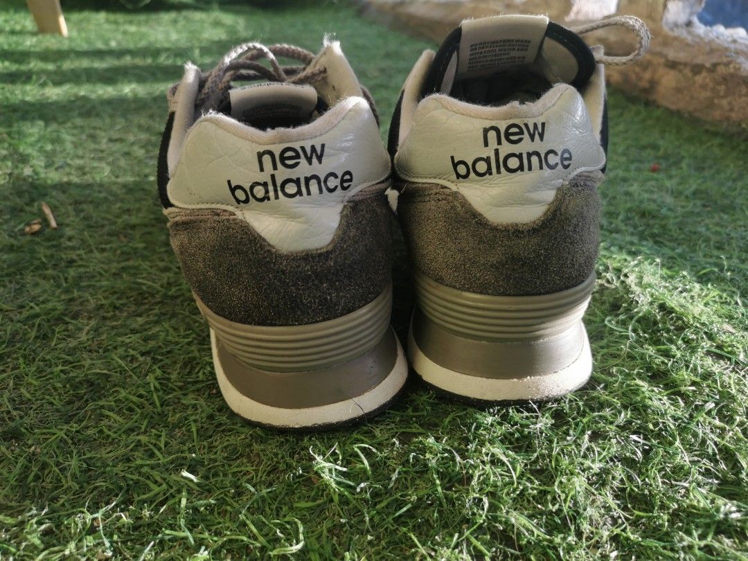 New Balance 574 Classic Sneakers (Category: Sneakers) located in Cagayan de Oro. Submitted by jerichox01 (Listing ID 1427777211, Image 2). Description: New Balance 574 Classic sneakers in gray and black. Features the iconic "N" logo on the sides. The shoes have gray laces and a white midsole. The heel area has "new balance" printed on it. The soles are black with some wear. The tongue has "new balance classic 574" printed on it..