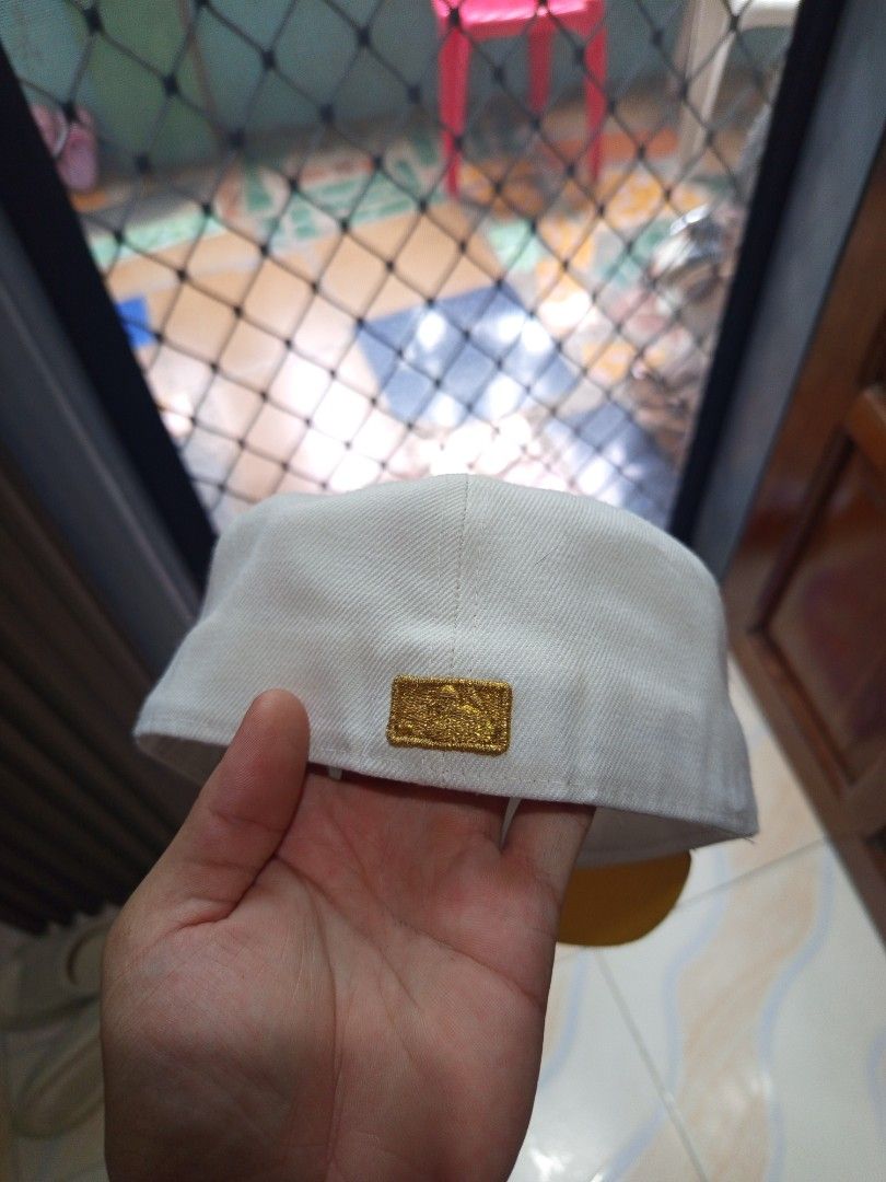 New Era 59FIFTY NY Yankees Cap (Category: Caps & Hats) located in Davao. Submitted by vaness041421 (Listing ID 1427769469, Image 3). Description: New Era 59FIFTY cap features the iconic NY Yankees logo in gold. The cap has a white crown and a yellow brim. The New Era logo is also visible on the side. The interior features the 59FIFTY size tag. A stylish and classic accessory for any Yankees fan..