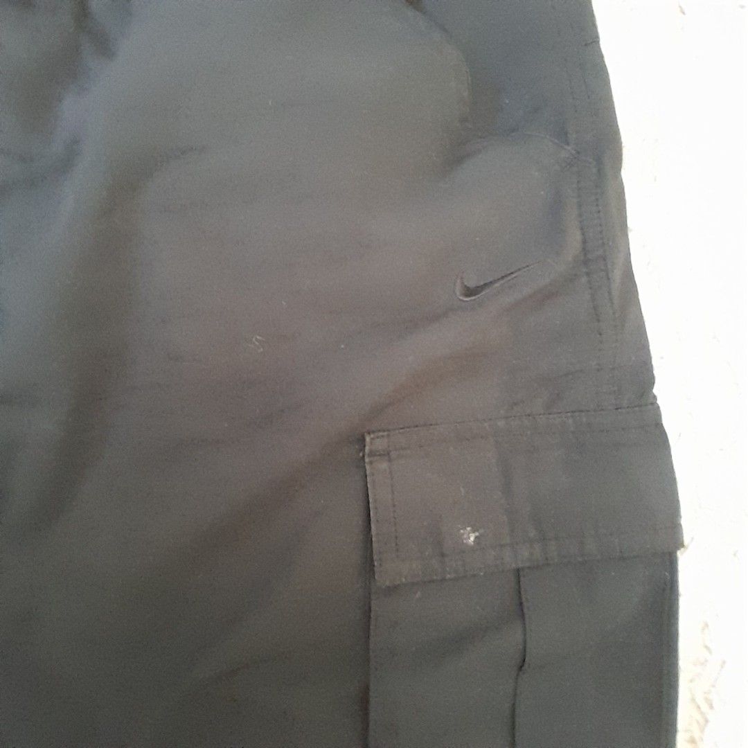 Nike Athletic Dept Shorts - XL (Category: Shorts) located in Baguio. Submitted by UrbanFlip (Listing ID 1427647338, Image 2). Description: Black Nike shorts with an elastic waistband. Features a cargo pocket on the side. The tag indicates an XL size. Made in Indonesia. The shorts have a Nike logo on the side..