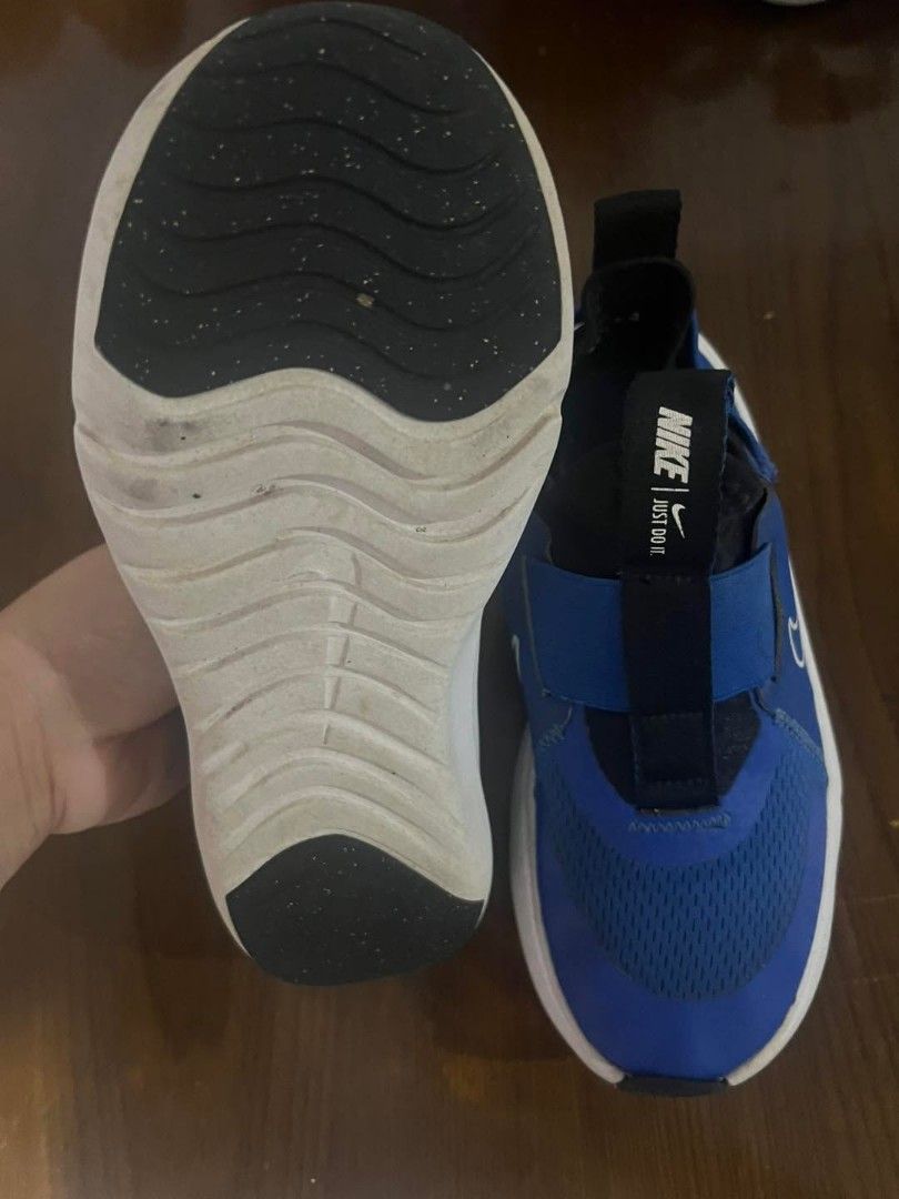 Nike Slip-On Sneakers Blue (Category: Sneakers) located in Marikina City. Submitted by caiteeekat (Listing ID 1427650871, Image 3). Description: Blue Nike slip-on sneakers. Features a mesh upper and a white sole. The Nike logo is visible on the strap and the side of the shoe. The shoes have a pull tab at the back for easy wear..