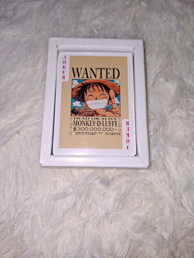 One Piece Poker Playing Cards (Category: Board Games & Puzzles) located in Talisay. Submitted by zhi_nel (Listing ID 1427751459, Image 2). Description: Complete deck of One Piece poker playing cards. The cards feature various characters from the anime. The box has a "Wanted" poster design with Monkey D. Luffy. The deck includes two joker cards. The cards are in a white box. Bought from Vietnam 🇻🇳.