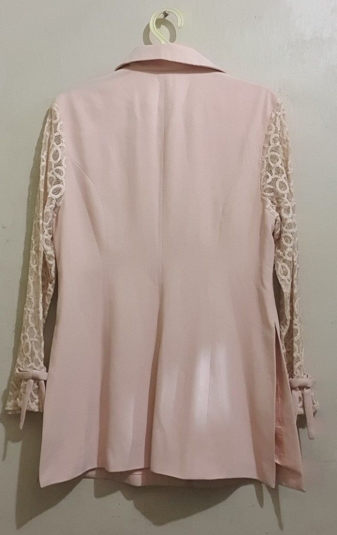 Pink Blazer with Lace Sleeves (Category: Coats, Jackets and Outerwear) located in Marikina City. Submitted by thezoneheads (Listing ID 1427718763, Image 2). Description: Elegant pink blazer featuring lace sleeves and a classic collar. It has three buttons down the front and two pockets. The sleeves have tie details at the cuffs. The back of the blazer has a simple, tailored design..